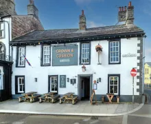 An external  image of a traditional Inn , the Crown and Cushion Appleby  with outside seating.