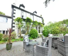 View of Fairfield House and Gardens and outdoor seating in Bowness-on-Windermere.
