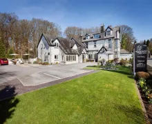 An image of the large detached Hawksmoor Guest House with parking and outdoor seating  near Windermere, Lake District
