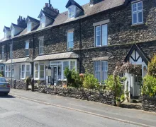 An external image of Montfort Cottage Guest House in the centre, a Lakeland stone faced property near Windermere in the Lake Distrct