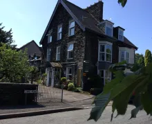 An external view of the four star Rocklea Guest House, with a traditional Lakeland stone appearance in Windermere, Lake District.