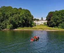 A view of the four star Storrs Hall Hotel and gardens  taken from Lake Widermere.