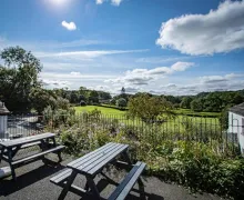 A view outside of the The Brown Horse Inn at Winster, near Bowness-on-Windermere with outside seating and wide ranging views over the rolling countryside of the Lake District