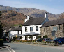 The Crown inn Coniston,Lake District  a white painted Inn with high fells in the background